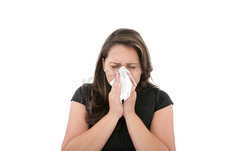 擦鼻涕摄影照片_感冒或过敏的女人擦鼻子或擤鼻涕。