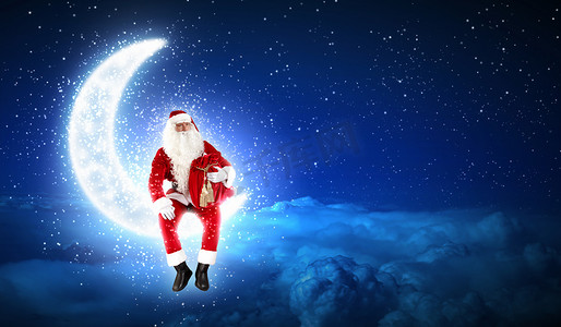 月亮装饰摄影照片_坐在月亮上的圣诞老人照片