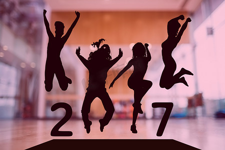新年地板摄影照片_跳跃的人形成 2017 年新年标志的剪影