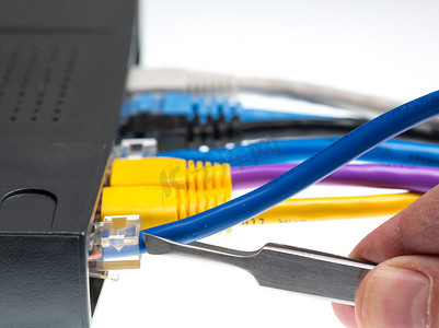 网络布线摄影照片_用于网络防御概念的 Cat5 电缆和路由器