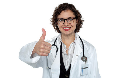 医生竖起大拇指摄影照片_成功的年轻医生竖起大拇指