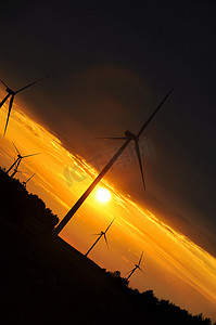 日出的风摄影照片_在美好的日落期间的风轮机