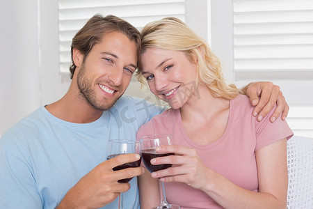 幸福的夫妻在沙发上喝红酒