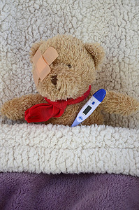 感染者摄影照片_卧床不起和生病的棕色泰迪熊