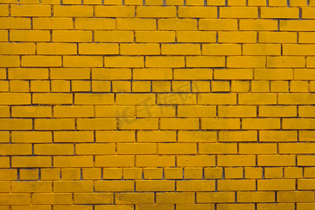 与老黄色被绘的砖墙的背景