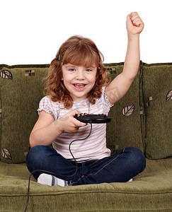 孩子电子游戏摄影照片_小女孩玩电子游戏并获胜