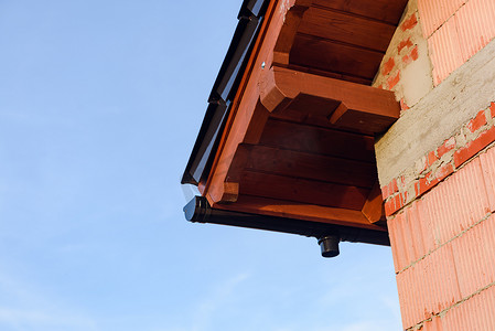 外墙施工摄影照片_在建屋顶的未完工红砖房外墙。