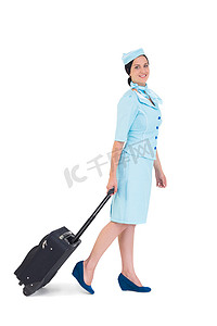 带着手提箱走路的漂亮空姐
