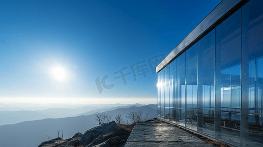 透明杯子装冰块摄影照片_在晴朗的蓝天下，棕色山上的透明玻璃墙建筑