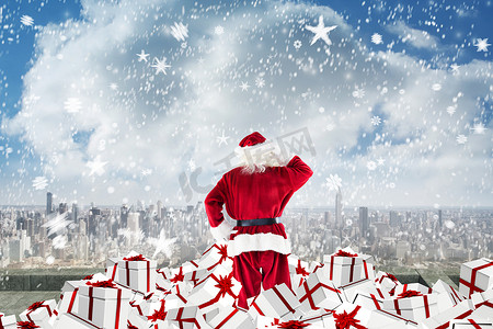 阳台冬天摄影照片_圣诞老人站在礼物堆上的合成形象