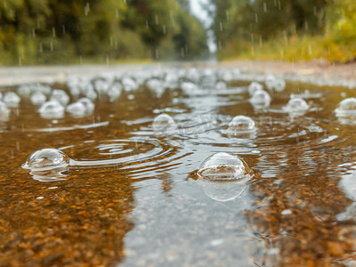 雨中路上的水坑里冒着泡泡。
