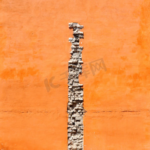 砖裂缝在橙色墙壁