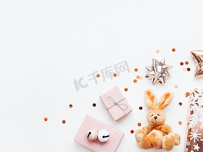 金色兔子摄影照片_粉色阴影下的节日礼物 — 毛茸茸的玩具兔，礼物 w