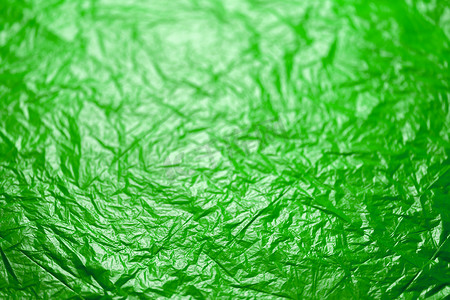 具有选择性聚焦的皱巴巴的飞碟绿色聚乙烯薄膜抽象背景