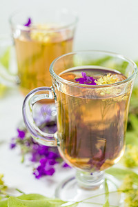 菩提树花草茶，装在透明熟料玻璃杯中，配以菩提树果酱
