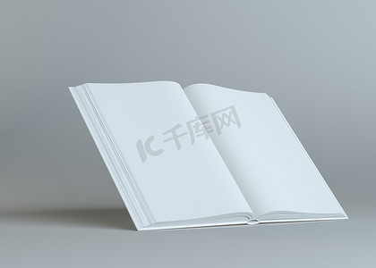 日记页面摄影照片_在灰色背景的白色空的本打开的书