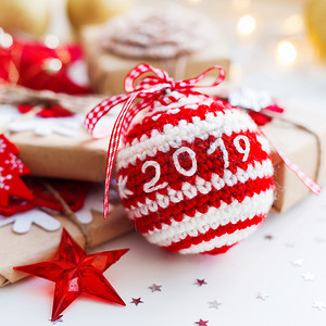 2019 年圣诞节和新年背景与钩编手工球、圣诞树的礼物和装饰品。