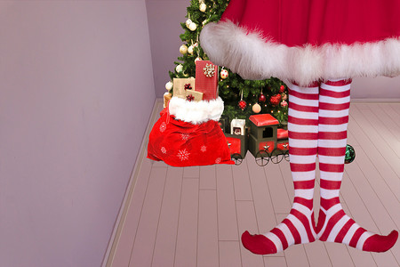 国潮精灵摄影照片_可爱的女孩，长着尖尖的精灵脚，穿着精灵绑腿，站在一个房间里，房间里有一棵圣诞树，背景是圣诞老人袋子，里面装满了礼物