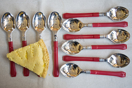 酸乳摄影照片_彩色勺子组合物上的楔形意大利乳清干酪馅饼