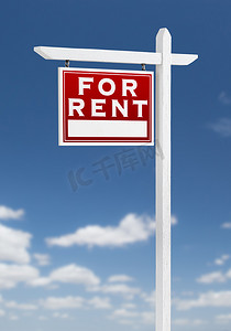 房地产蓝色广告摄影照片_在蓝天白云上左面出租房地产标志。