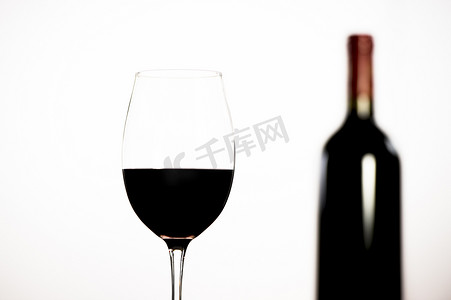 白色背景中的红酒瓶和玻璃