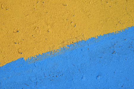蓝色和黄色彩绘混凝土墙体纹理
