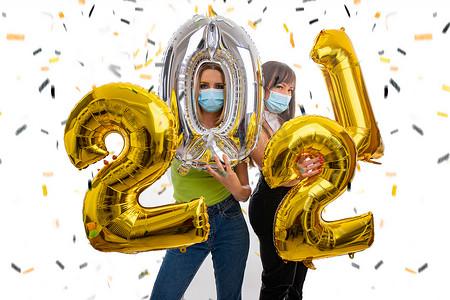 快乐的女孩们戴着口罩庆祝 2021 年新年