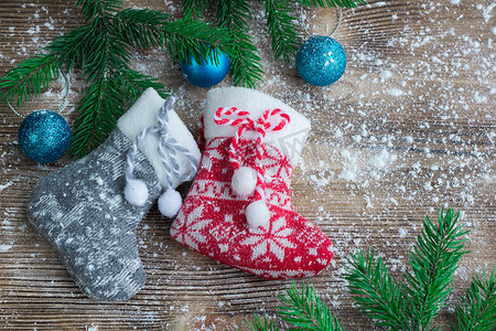 雪地木制背景上的两只圣诞袜，蓝色球