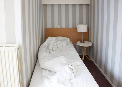 旅馆房间摄影照片_简单的旅馆房间，单人床