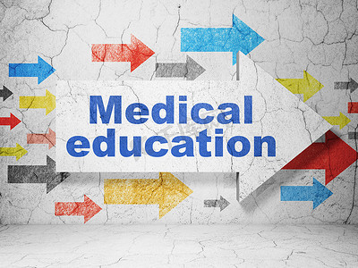 蓝色背景墙背景摄影照片_教育理念： 箭头与垃圾墙背景上的医学教育