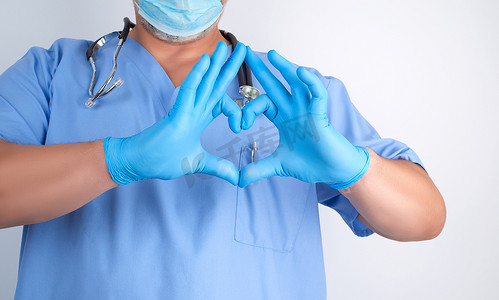 蓝色制服和乳汁手套的医生显示心脏姿态ne