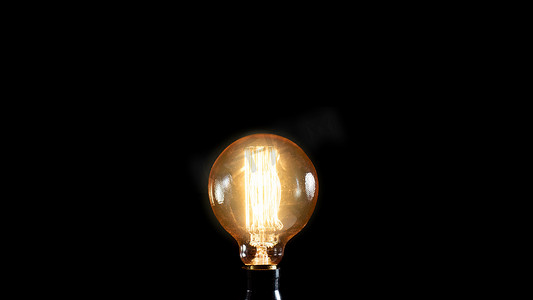 电商背景台打光摄影照片_黑色背景上的老式爱迪生灯。