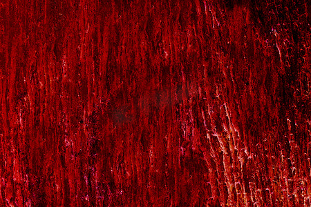 深红色背景摄影照片_用于室内深红色热色调 c 的熔岩花岗岩墙板表面