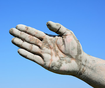 男人张开的手掌沾满了泥巴