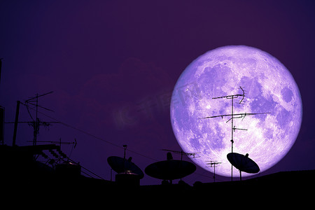 在屋顶的满干草月亮行星后面剪影卫星天线