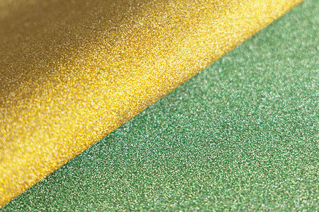 金色和绿色波浪柔软闪亮的闪光纸质感。
