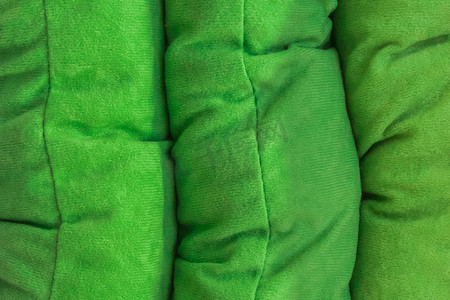 纺织物摄影照片_织物绿色翠绿材料彩色纺织物复古样品背景设计，特写