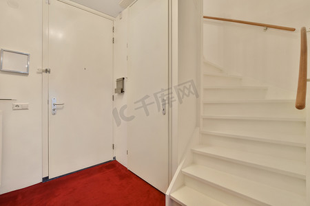 一间带楼梯和白色门的小房间