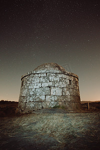 夜晚的岩石建筑，背景布满星星