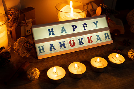 四根蜡烛，带有出现日历灯箱，上面有文字“光明节快乐”传统燃烧的圣诞蜡蜡烛，上面有圣诞节倒计时的数字。