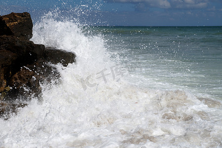 冲击海浪摄影照片_巨大的白色海浪冲击着海岸