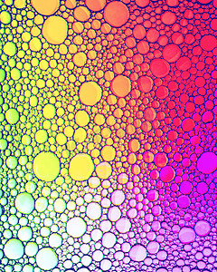 椭圆形不规则图形摄影照片_水面上彩色油滴的顶视图。