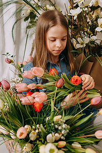 复活节照片摄影照片_两个女孩在一个美丽的复活节拍照区，里面有鲜花、鸡蛋、鸡和复活节兔子。