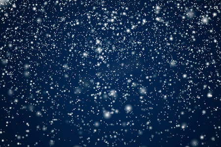 冬季假期和冬季背景，白雪落在深蓝色背景上，雪花散景和降雪颗粒作为圣诞节和下雪假期设计的抽象雪景
