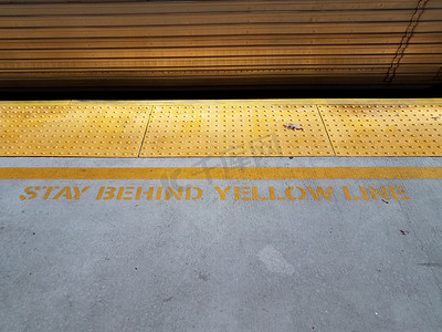 黄色触觉颠簸和火车并留在黄线标志后面