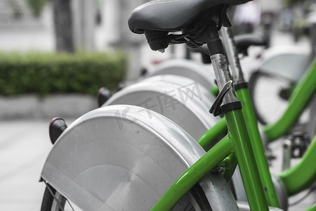 以电子支付方式环城出行的街头交通绿色混合租赁自行车在租赁网络停车场排成一列，等待骑行者进行自行车旅行。
