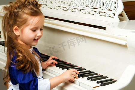 这个女孩在白色的三角钢琴前。