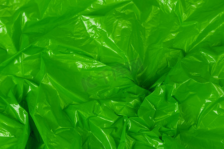 具有选择性聚焦的皱褶绿色聚乙烯薄膜抽象背景