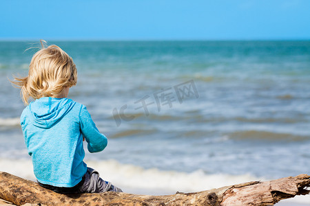 坐在海滩上的小孩