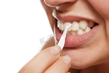 女人用塑料牙签清洁牙齿